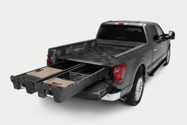 Gray pickup with a two-drawer truck bed storage system pulled out past the open tailgate