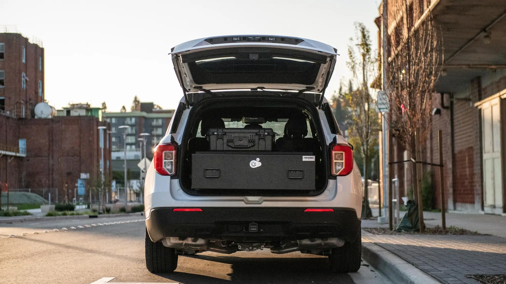 Ford Explorer with its liftgate open, showing a TruckVault drawer system in the cargo area