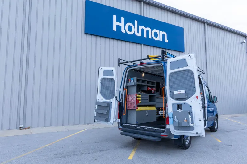 Upfitted work van with ladder rack at the Holman facility