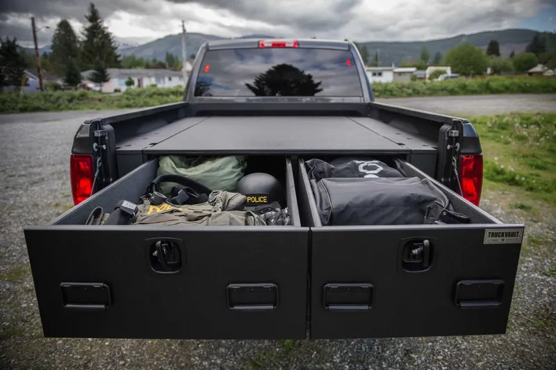 Pickup bed with two TruckVault drawers pulled out and loaded with gear