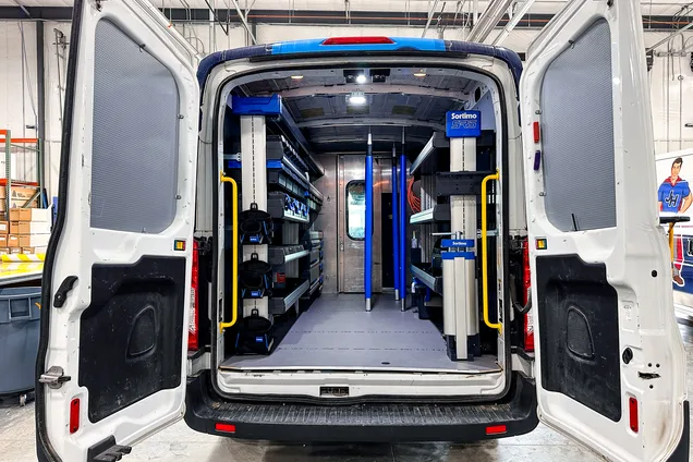 Upfitted work van interior with shelving and storage systems