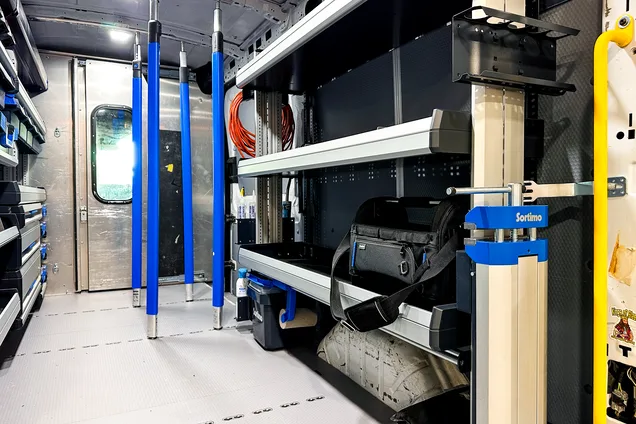 Sortimo van shelving system with organized parts bins installed in a work van