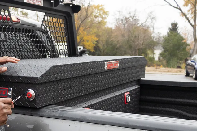 Saddle box and lo-side truck tool boxes installed in a pickup bed